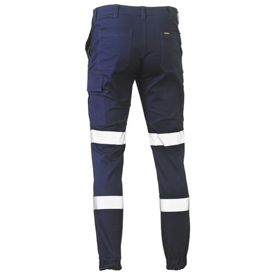 Navy cargo work pants with silver reflective tape at knees and calves, elasticated ankle cuffs, rear view showing cargo pockets