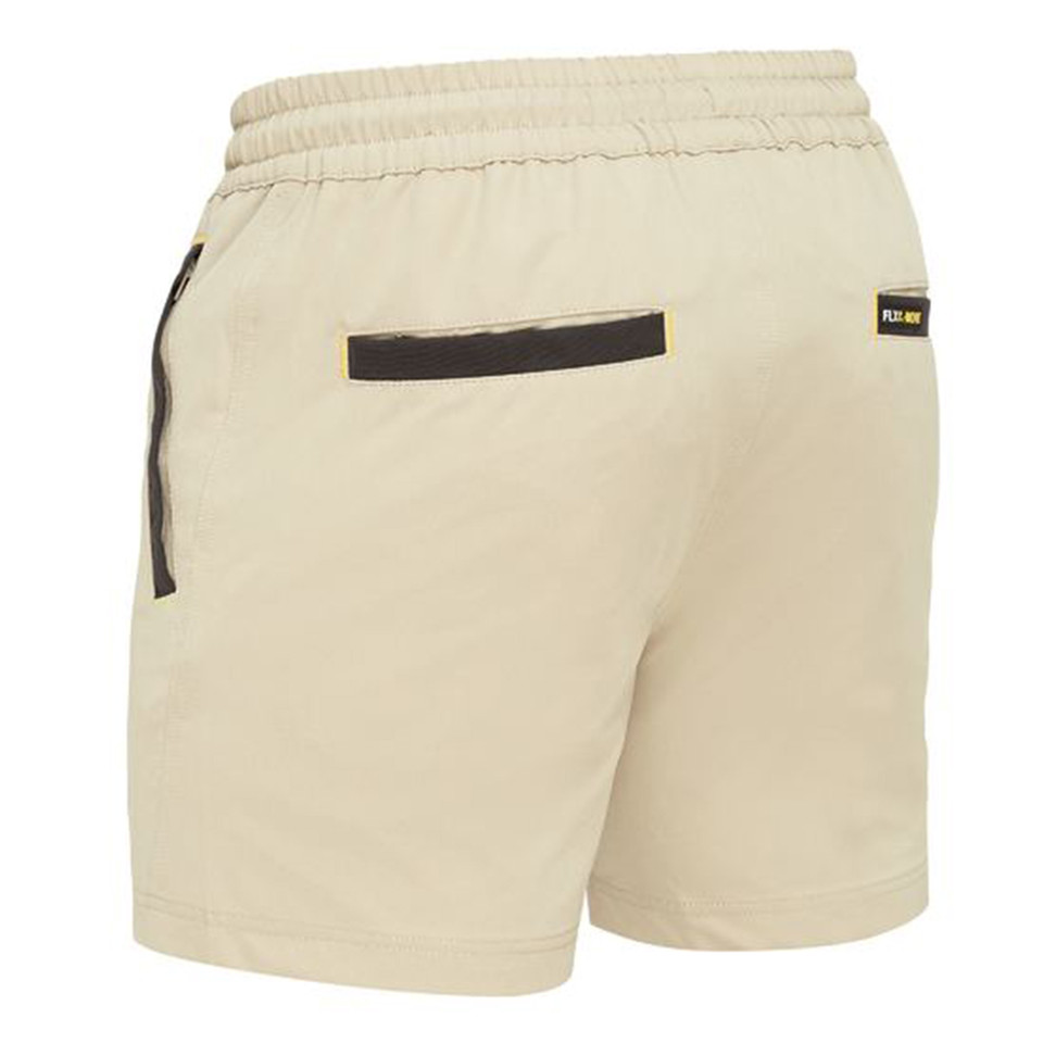 Stone coloured stretch shorts with elastic waistband and charcoal contrast trim on pockets