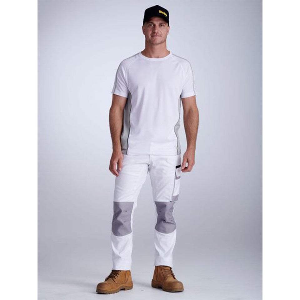 White cargo pants with grey knee pad panels and contrast stitching worn with matching white tee