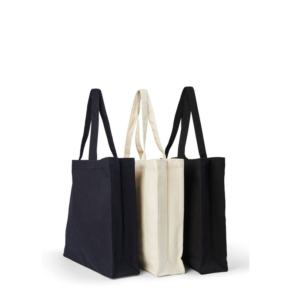 Navy, natural, and black heavy cotton canvas tote bags with long handles and structured gusset base