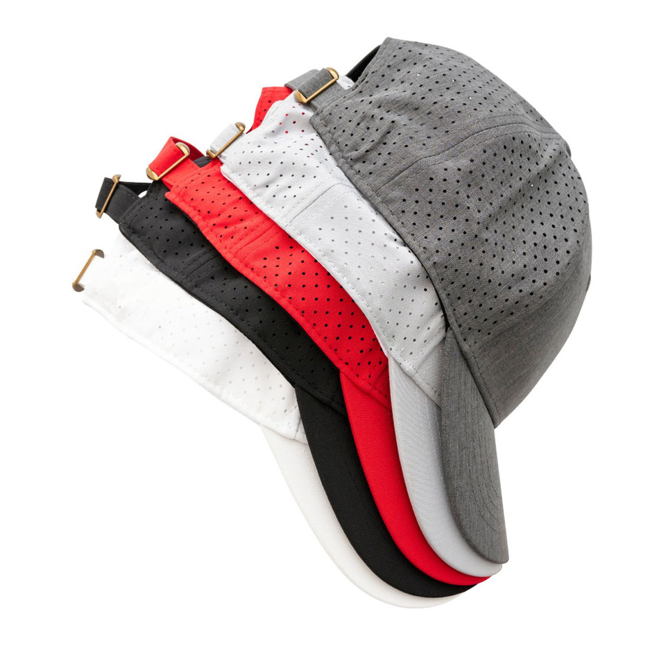 Perforated running caps in charcoal, white, red, and black with adjustable back straps and laser-cut ventilation holes