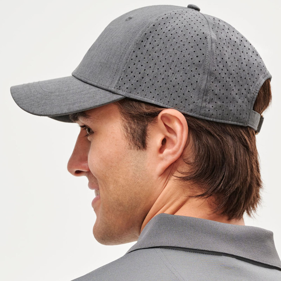 Man wearing charcoal grey laser-cut perforated running cap with structured curved brim, side profile view