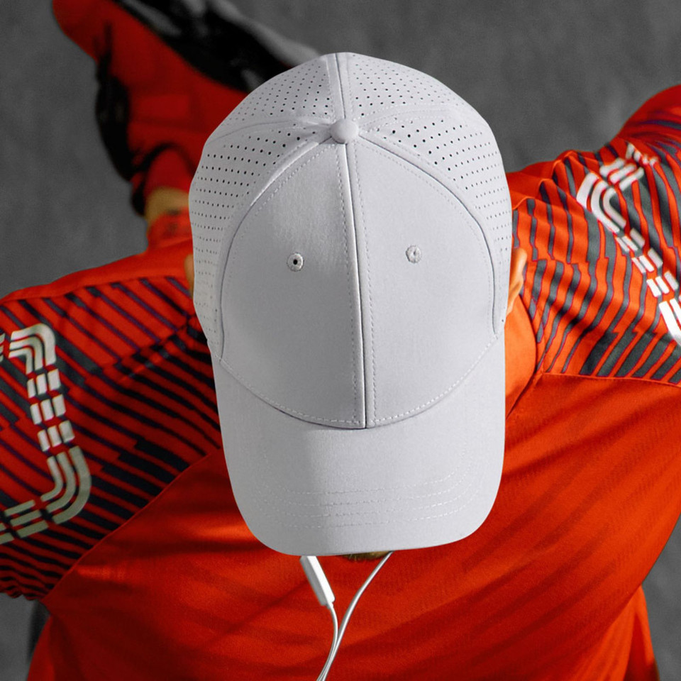 White performance cap with laser-cut ventilation panels and six-panel construction
