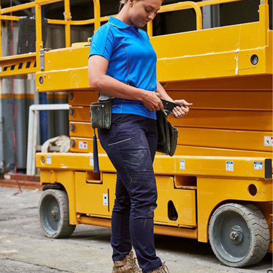 Navy cargo pants with multiple utility pockets and knee reinforcement panels paired with bright blue polo shirt
