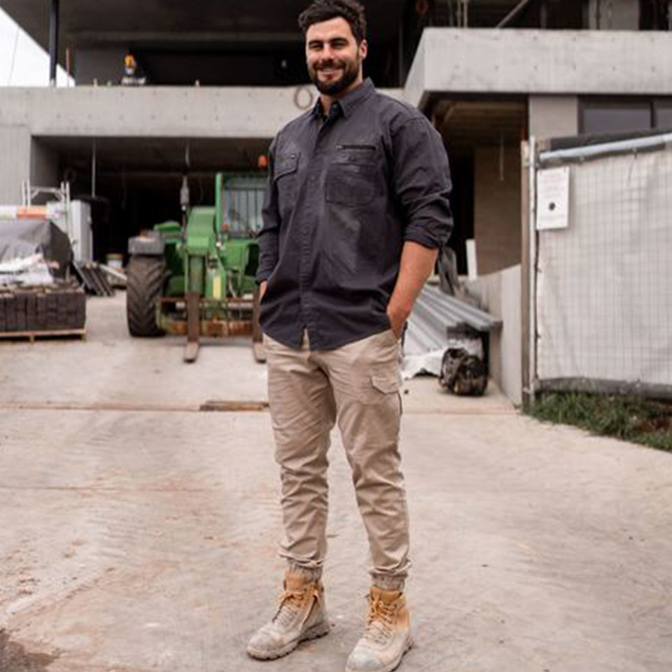 Charcoal long sleeve work shirt with chest pocket and button front worn with khaki cargo pants