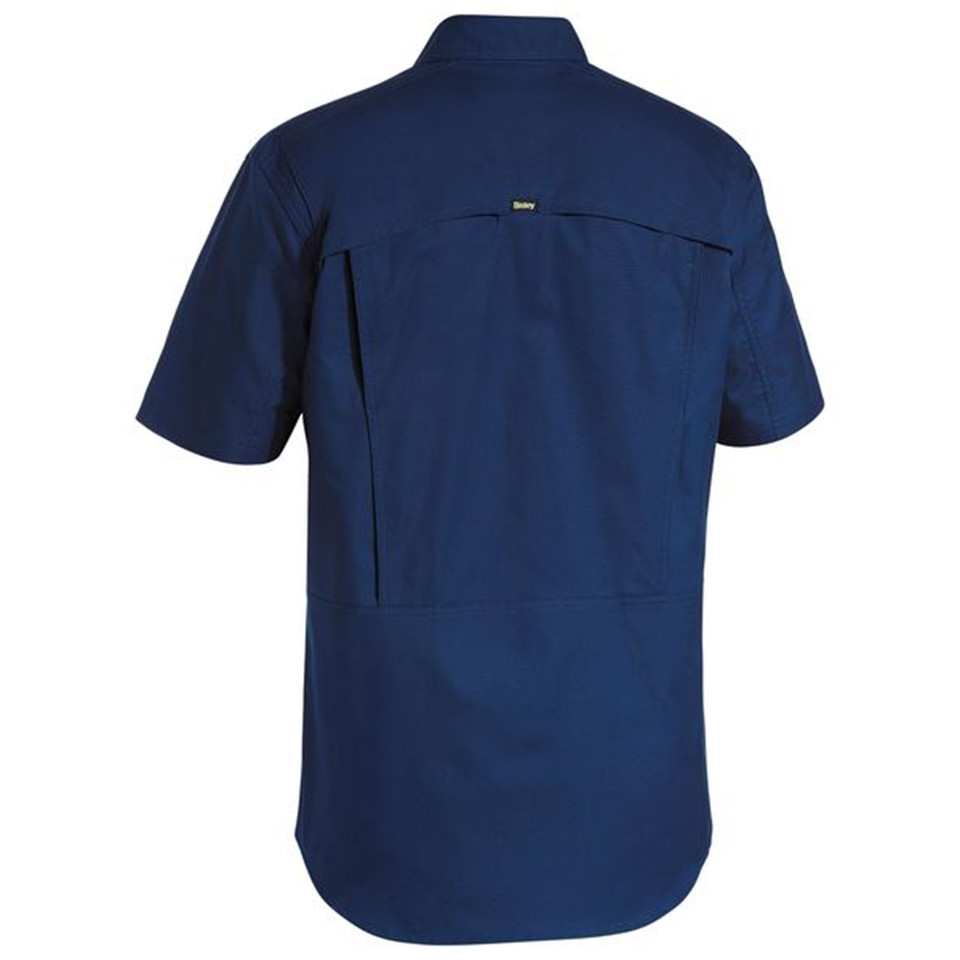 Navy blue short sleeve work shirt rear view showing utility back pocket and vented panel with logo tab
