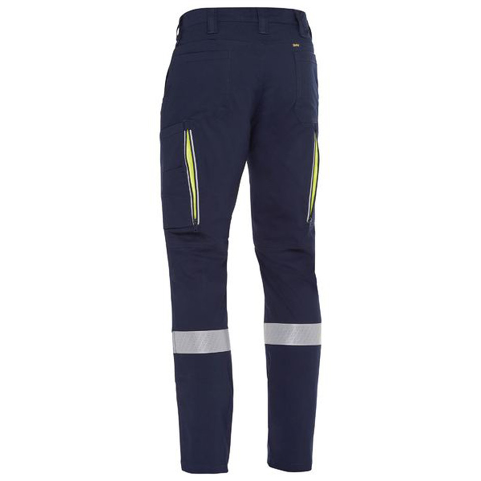 Navy stretch cargo pant rear view with hi-vis yellow vents, cargo pockets, and silver reflective tape bands at lower leg