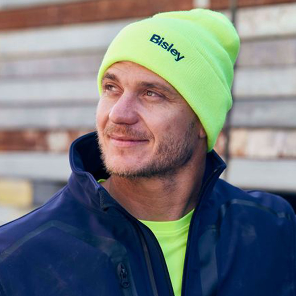 Safety yellow ribbed knit beanie with turned-up cuff and embroidered navy logo on front panel