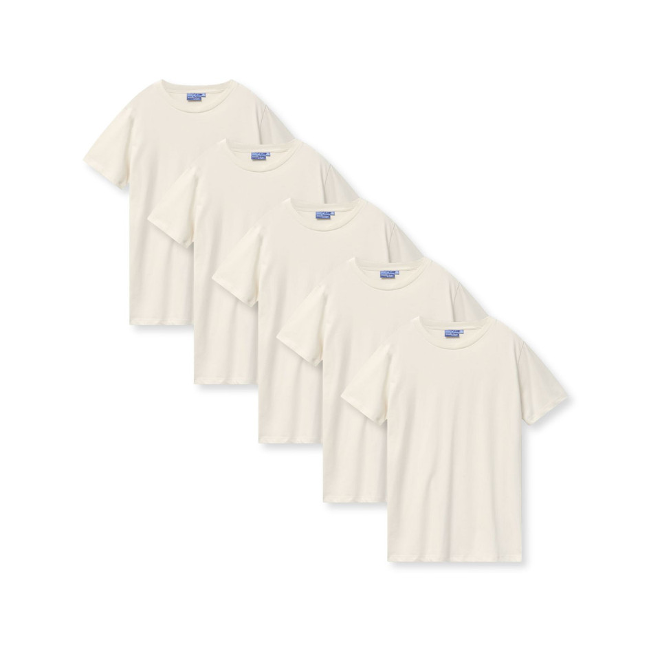 Five natural cream LOFT premium cotton crew neck tees arranged in overlapping diagonal flat lay