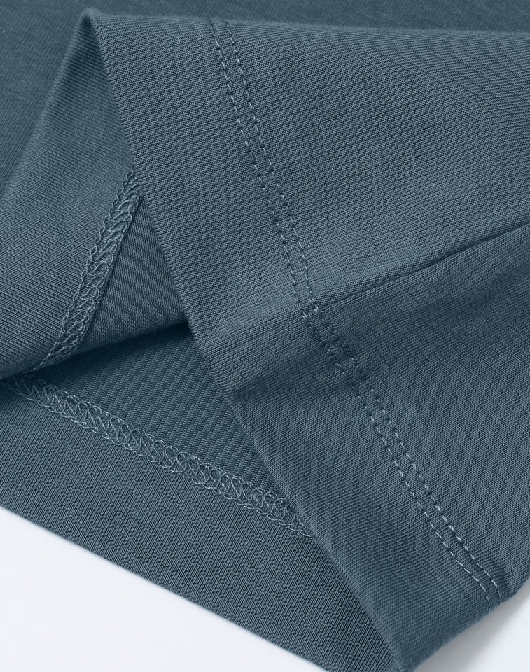 Slate blue crew neck tee showing detailed flatlock stitching on hem and sleeve seams