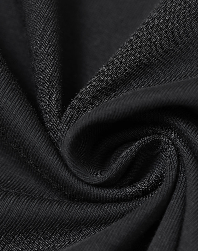 Black fabric with diagonal twill weave texture showing ribbed knit construction detail