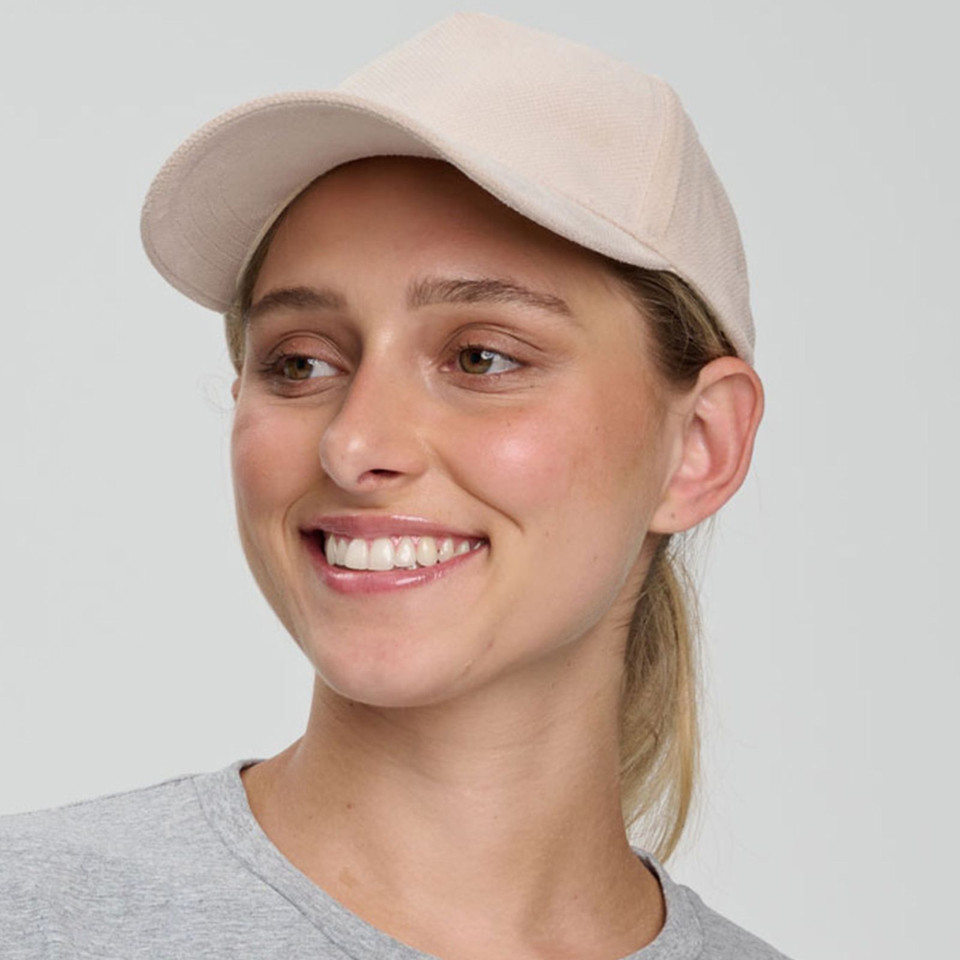 Soft pink five panel cap with structured crown and curved brim in jacquard texture