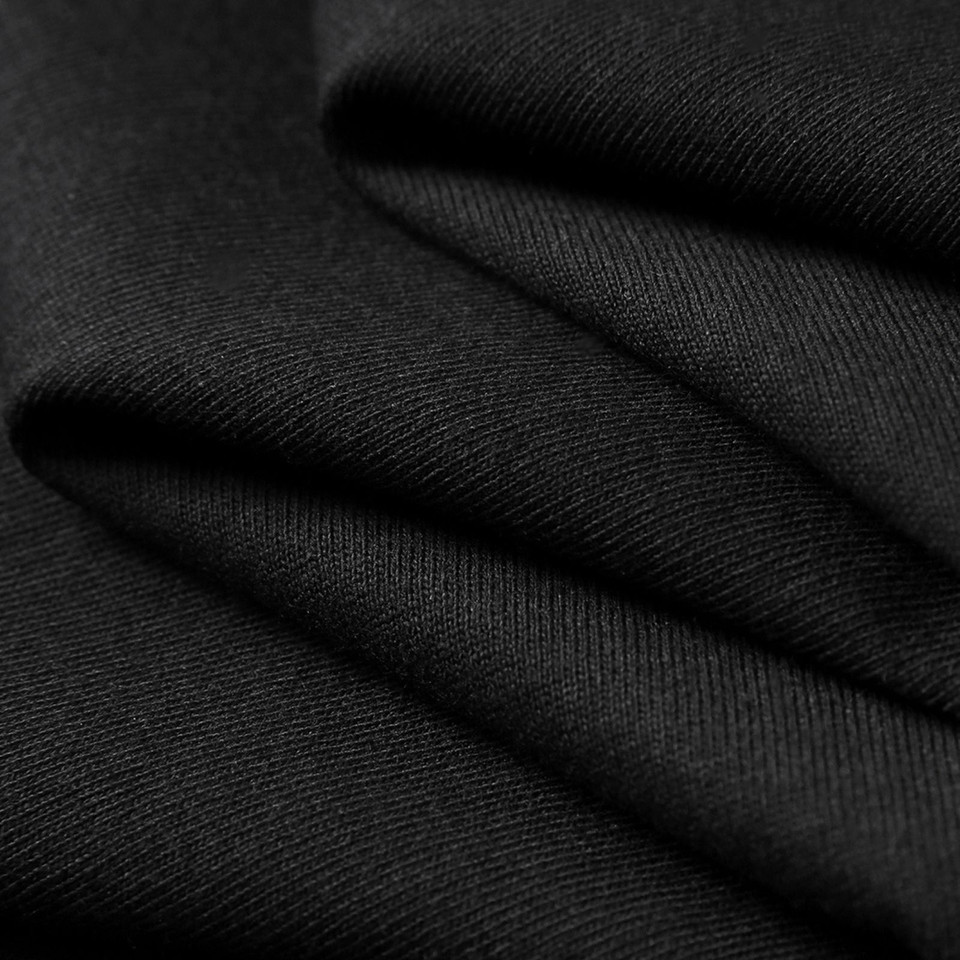 Black organic cotton t-shirt fabric with visible textured weave and soft drape