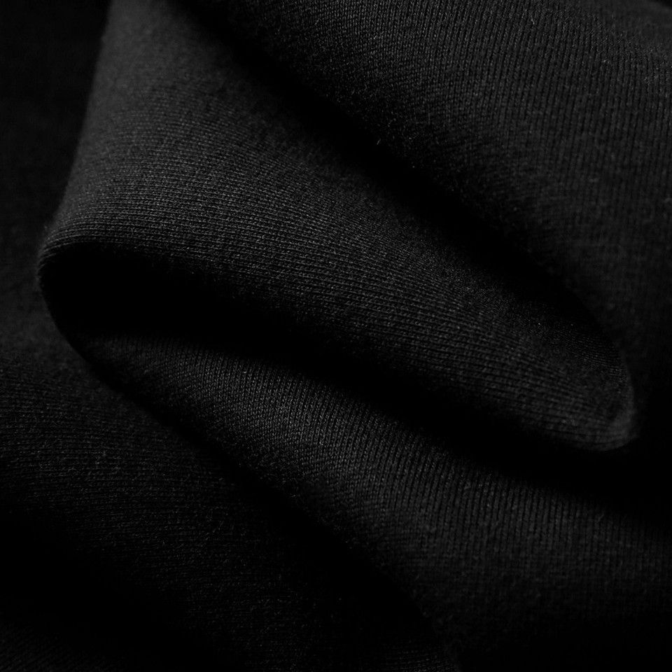 Black oversized hoodie with soft cotton-rich fabric texture and relaxed draped fit