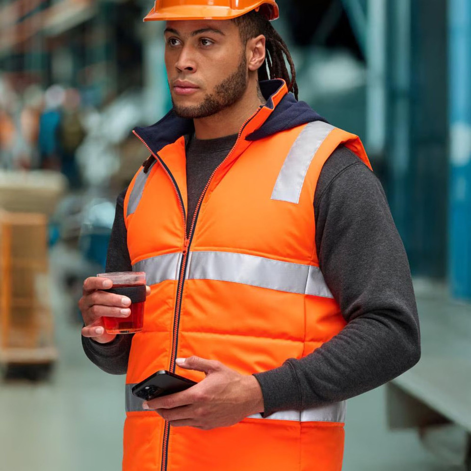 Orange high-visibility puffer vest with reflective silver tape and navy hood, front zip closure