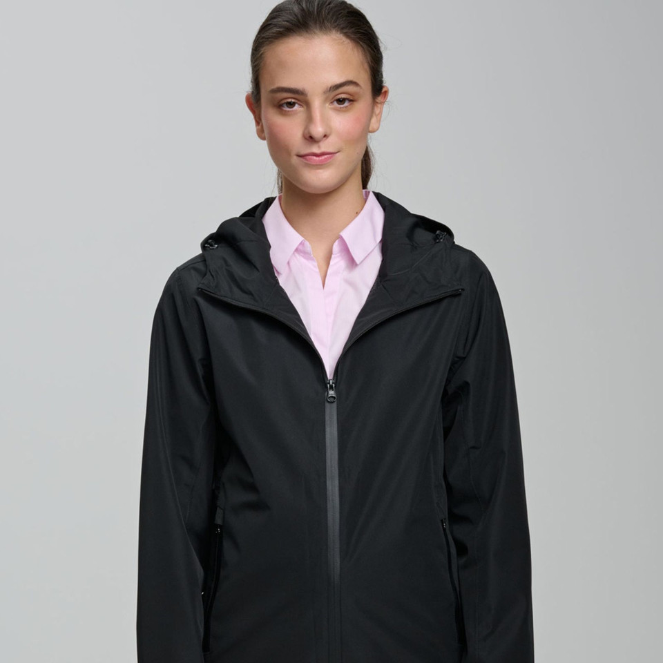 Woman wearing black recycled PET waterproof jacket with attached hood and centre-front zip, styled over pink shirt