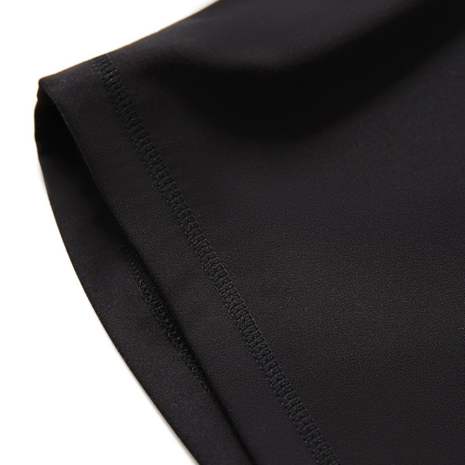 Black high-rise legging shorts with flatlock seam detail along leg opening