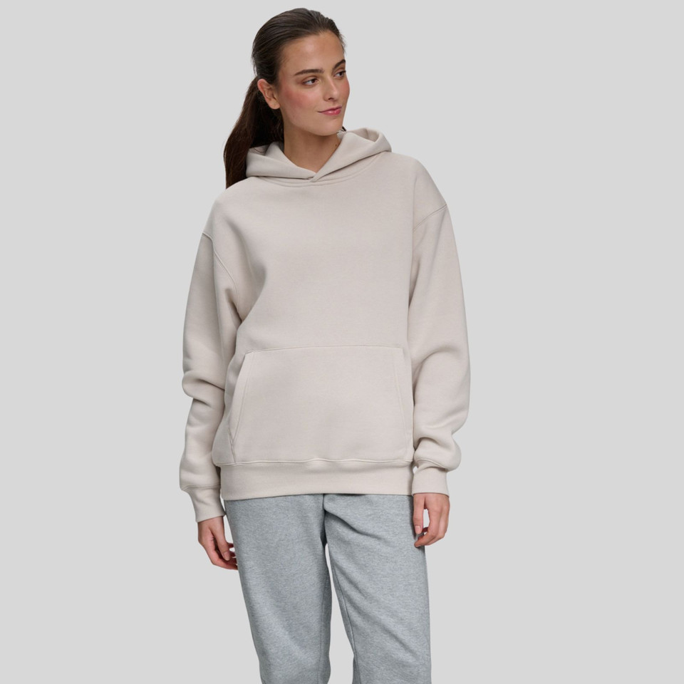 Sand oversized pullover hoodie with kangaroo pocket and grey marle sweatpants on model