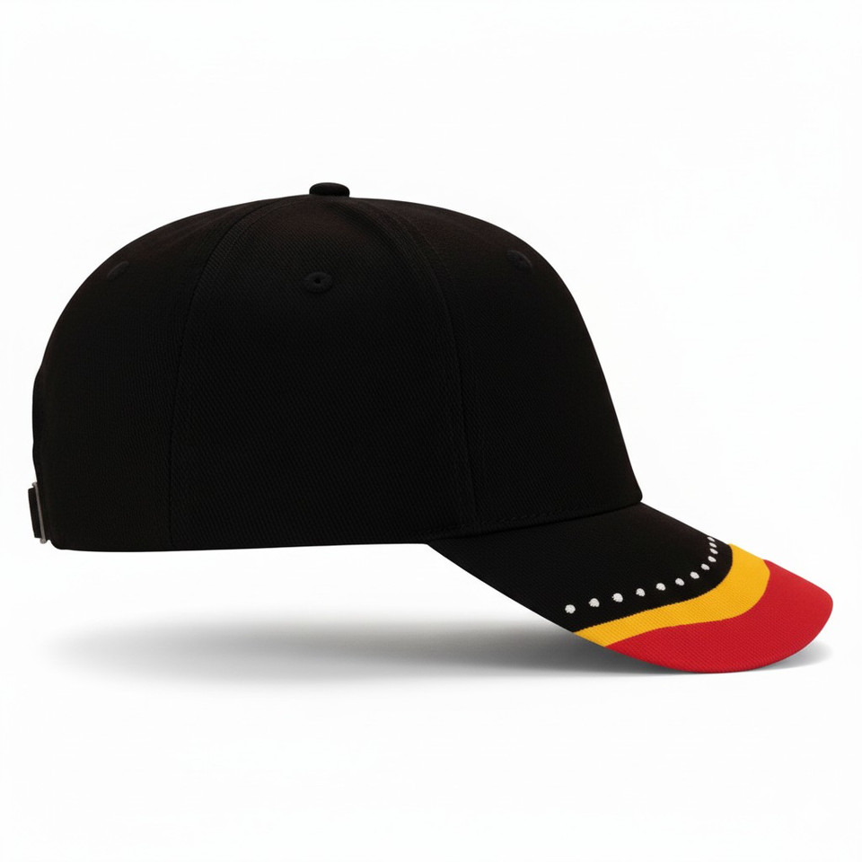 Black baseball cap with Aboriginal flag colours on brim and embroidered dot detail along peak edge