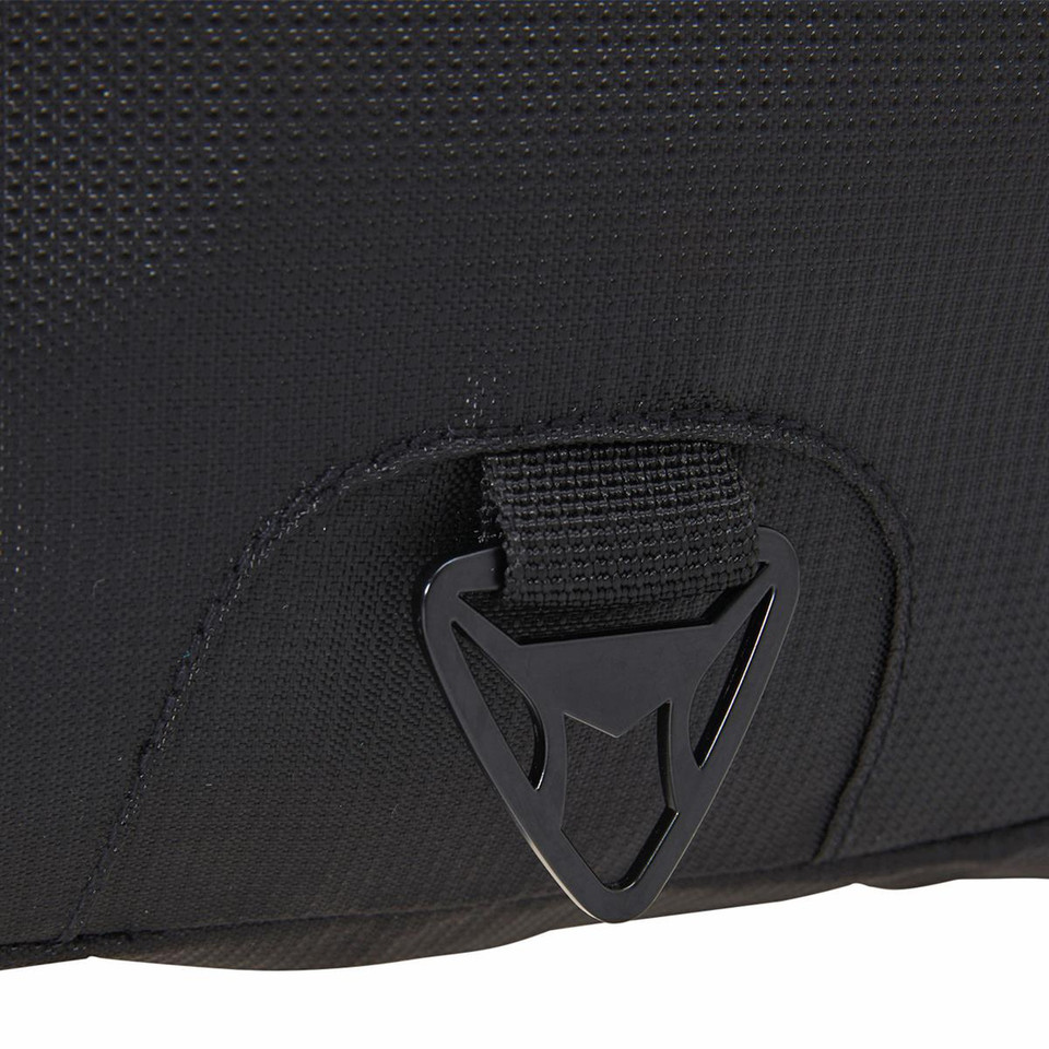 Black backpack showing plastic quick-release buckle closure detail and textured fabric construction