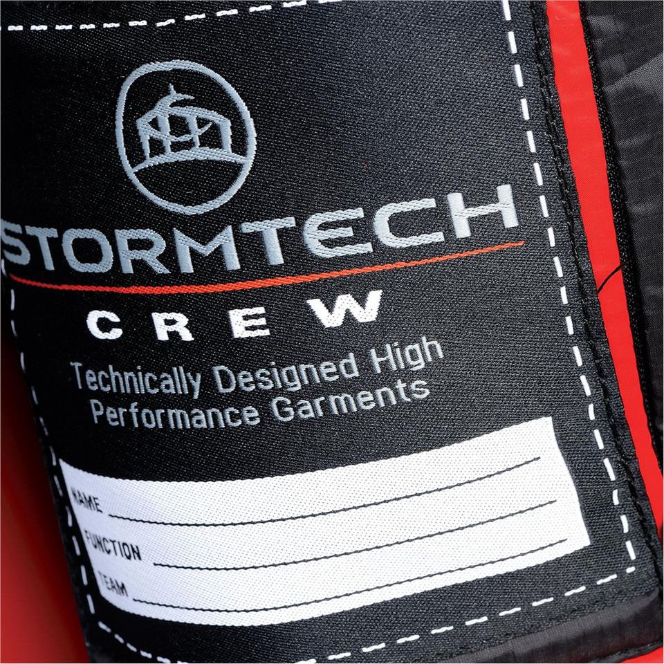 Stormtech Crew interior label on black thermal puffer jacket with red contrast lining and personalisation fields