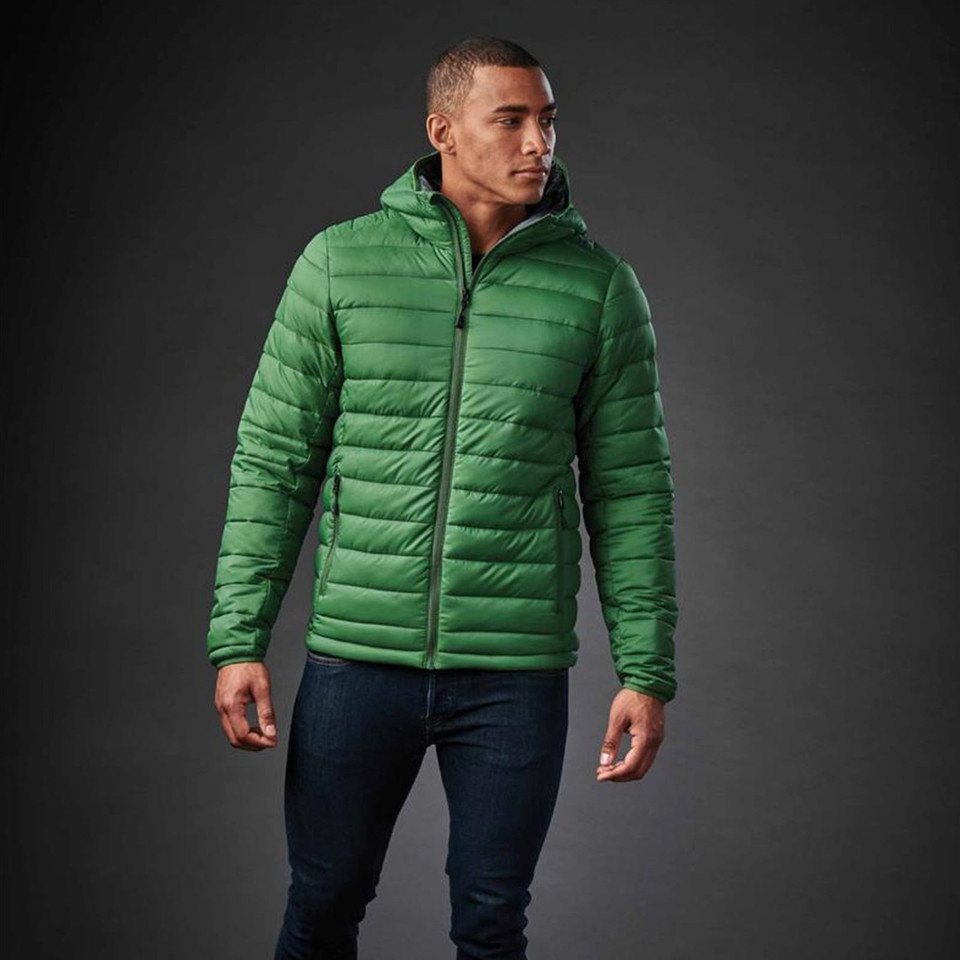 Man wearing a fern green quilted insulated hooded jacket with charcoal zip, horizontal baffle construction