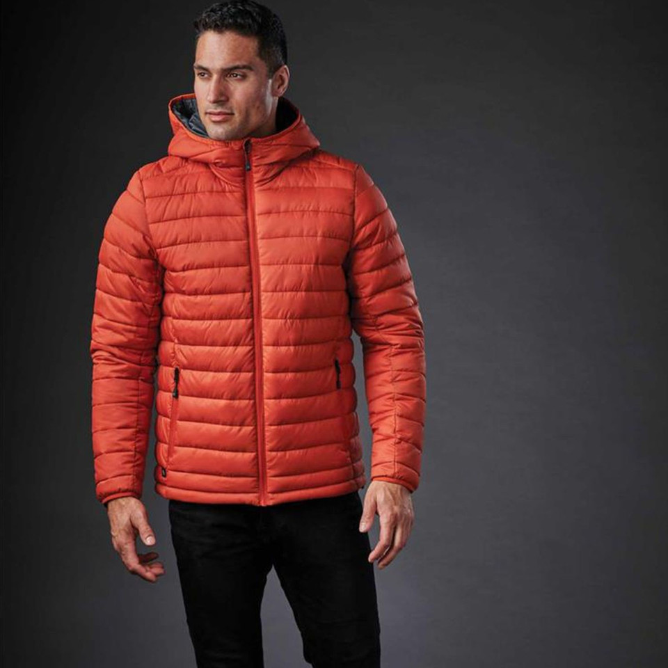 Man wearing burnt orange quilted hooded puffer jacket with contrast zip pockets and centre-front zip