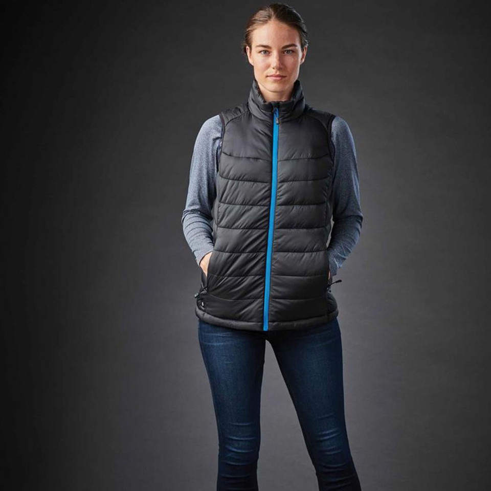 Charcoal quilted puffer vest with bright blue contrast zipper and side pockets on grey base layer