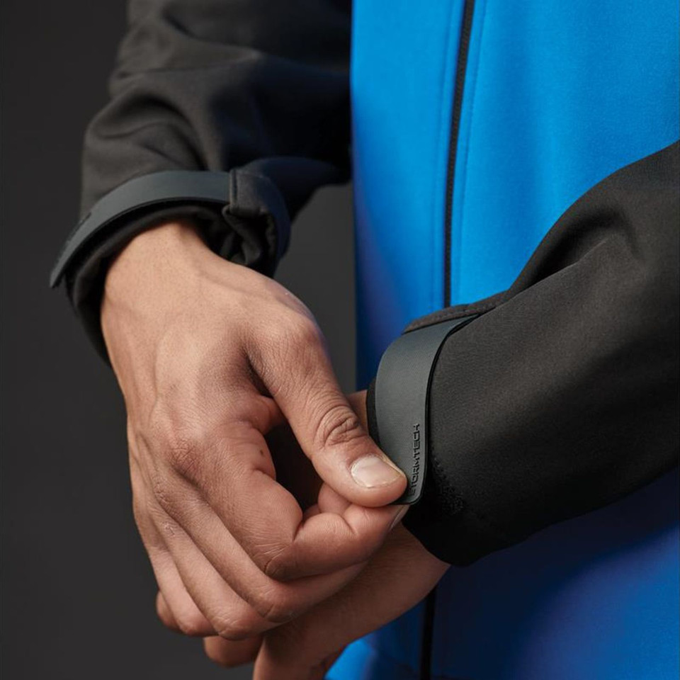 Charcoal grey softshell jacket with adjustable cuff tabs and contrast sapphire blue inner panel