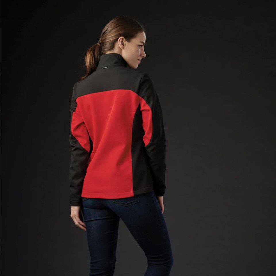 Woman wearing red and black two-tone softshell jacket, rear view showing contrast panel construction