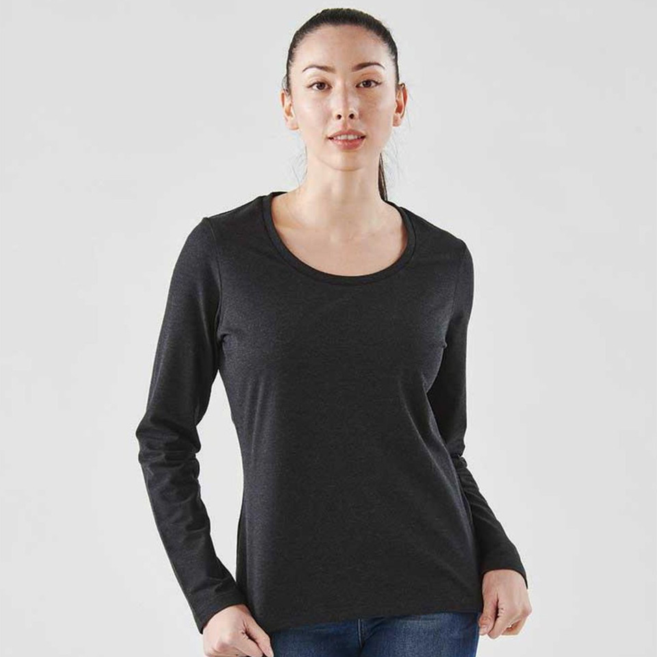 Woman wearing a charcoal marle long sleeve tee with a scoop neckline and smooth front panel