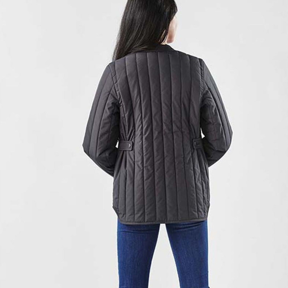 Woman wearing charcoal vertical-quilted thermal jacket with adjustable waist belt, rear view
