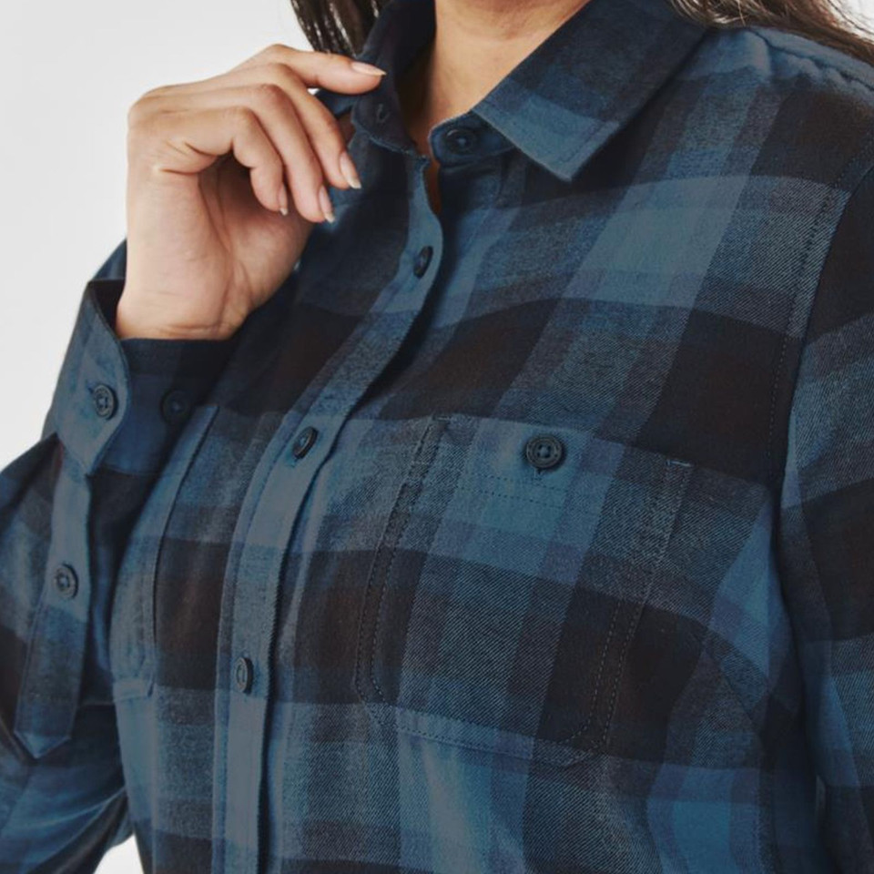 Woman wearing teal and black plaid flannel shirt with button front, chest pocket, and spread collar