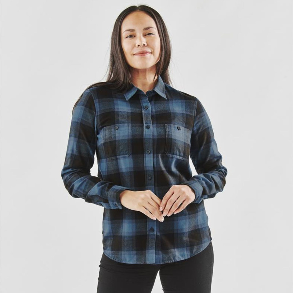 Woman wearing a steel blue and black plaid flannel shirt with button front and dual chest pockets