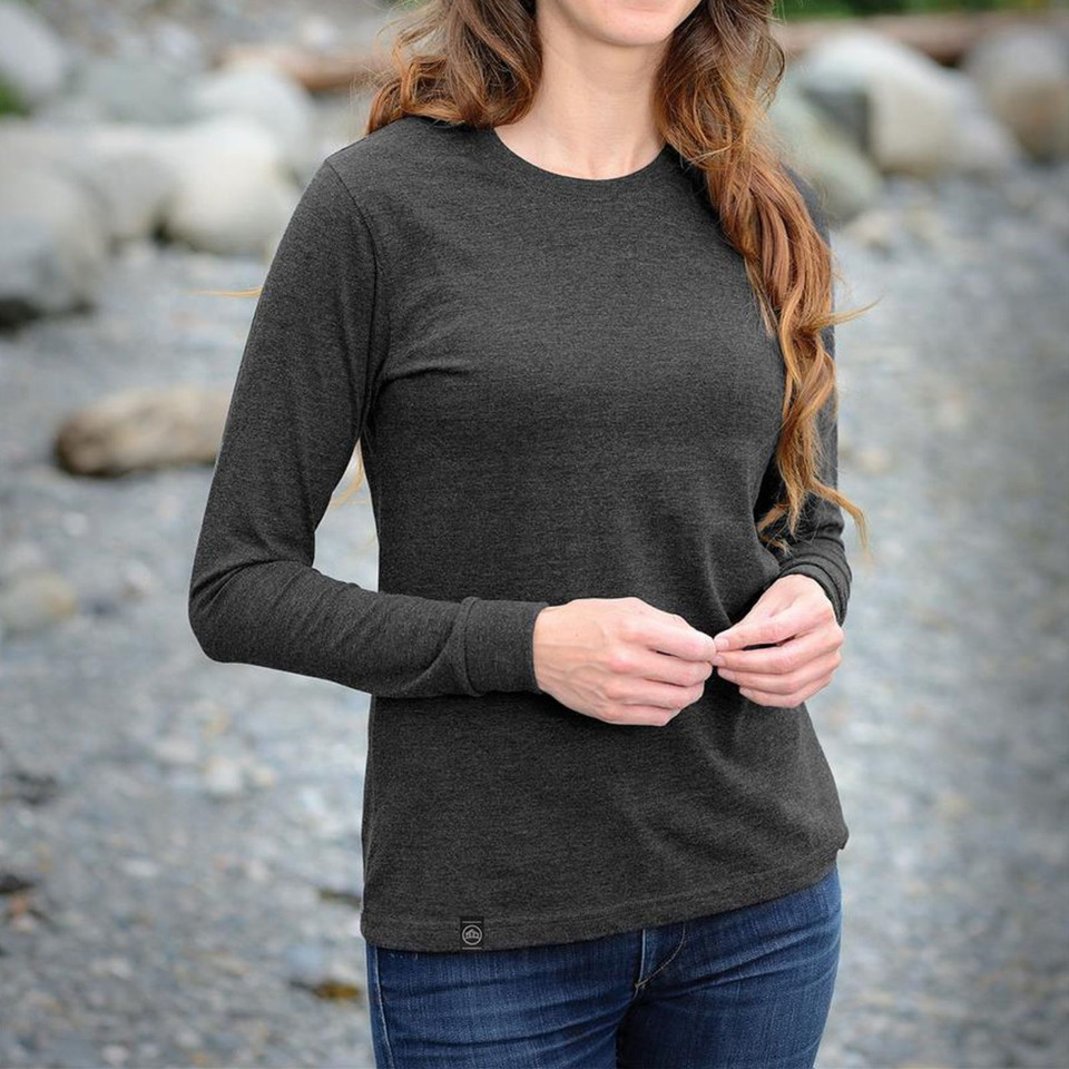 Woman wearing charcoal heather long sleeve crew neck tee outdoors, slim fit with ribbed cuffs