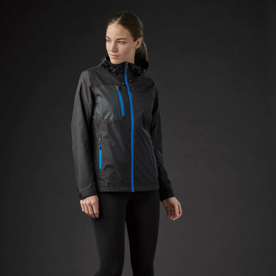 Woman wearing charcoal waterproof shell jacket with cobalt blue zip and chest pocket contrast detailing