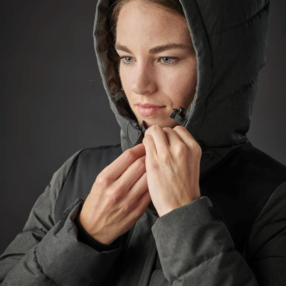 Woman adjusting chin guard on charcoal insulated hooded parka with structured hood and contrast panelling
