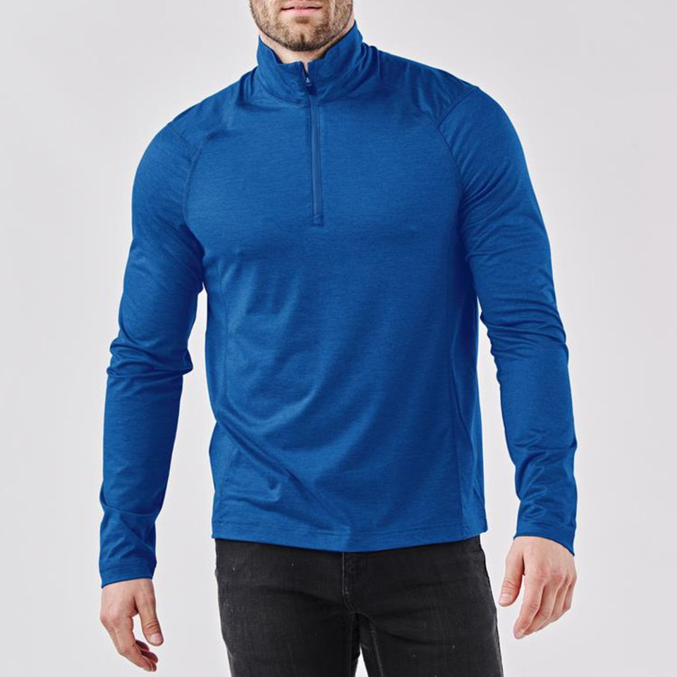 Man wearing royal blue quarter-zip pullover with high collar, raglan sleeves and textured recycled fabric