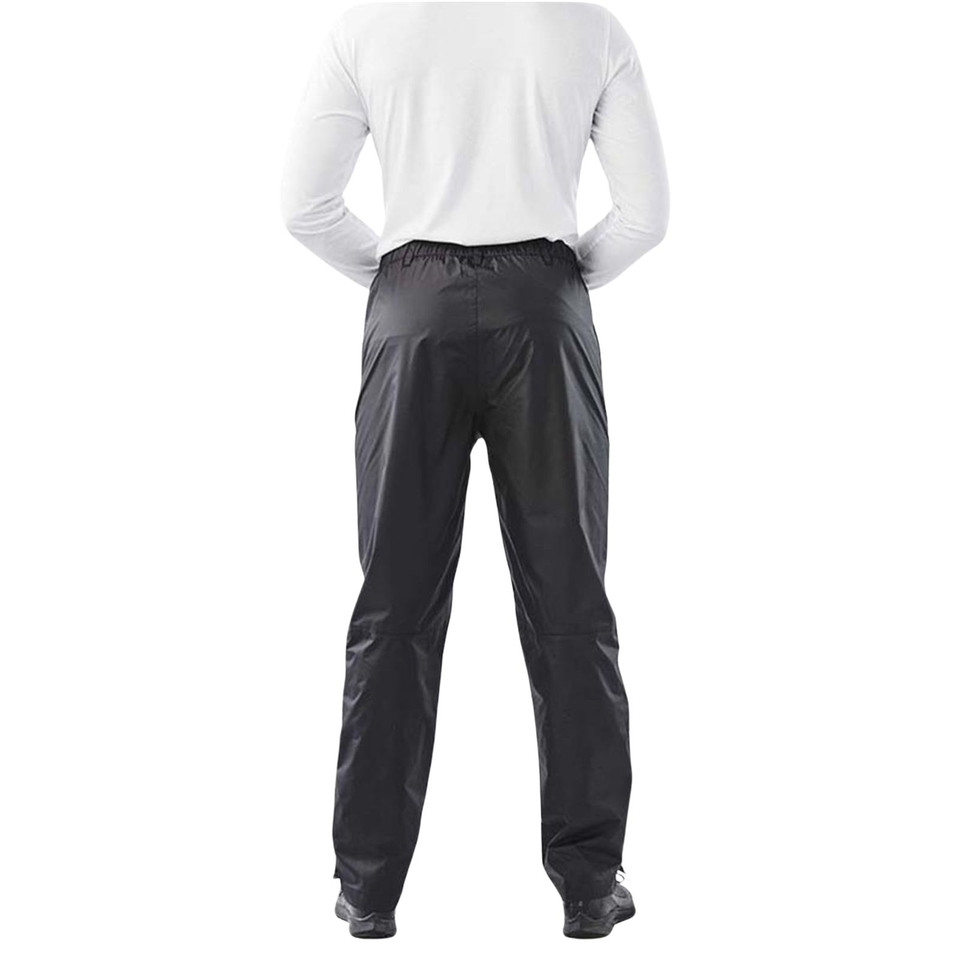 Rear view of black waterproof rain pants with elasticated waist and smooth shell fabric, worn by male model
