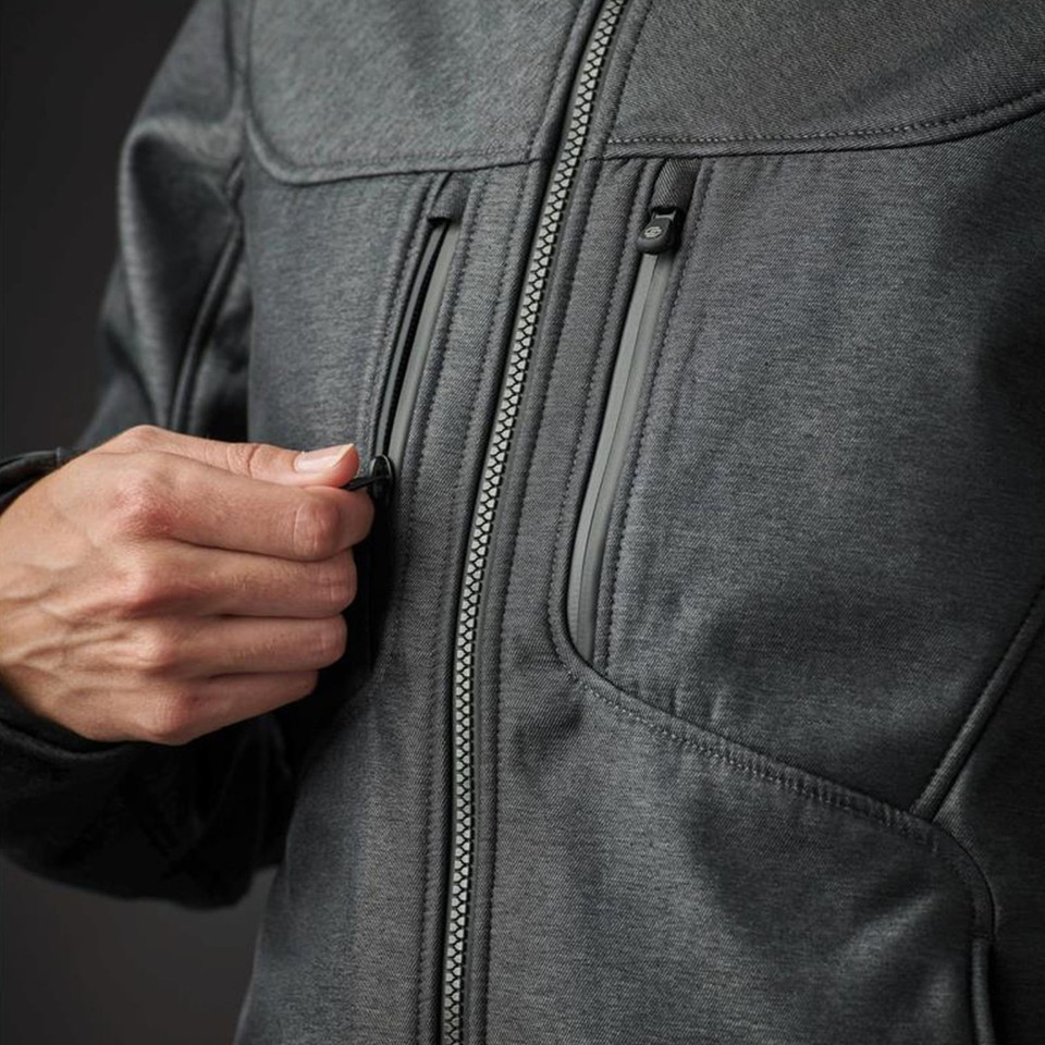 Close-up of charcoal marl softshell layer with zip chest pocket and main centre-front zip pull detail