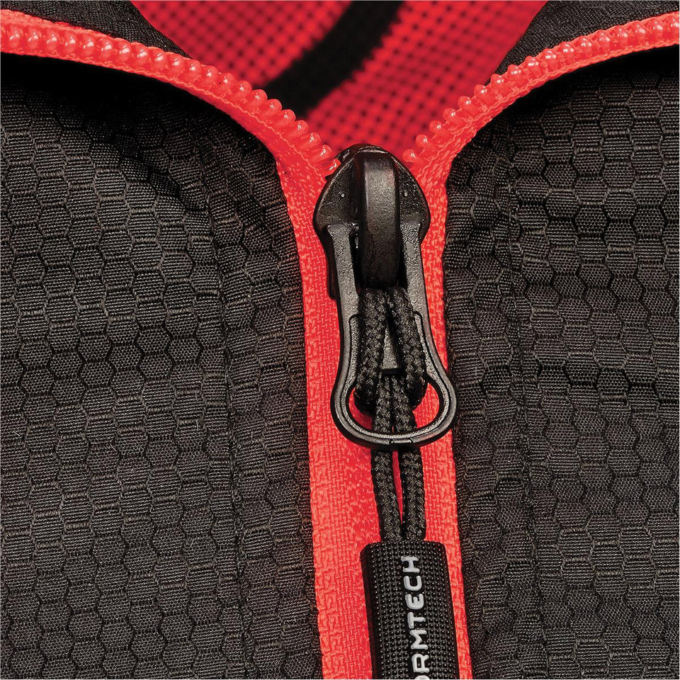 Close-up of charcoal honeycomb-texture jacket with red contrast zip tape, cord puller, and branded zipper garage