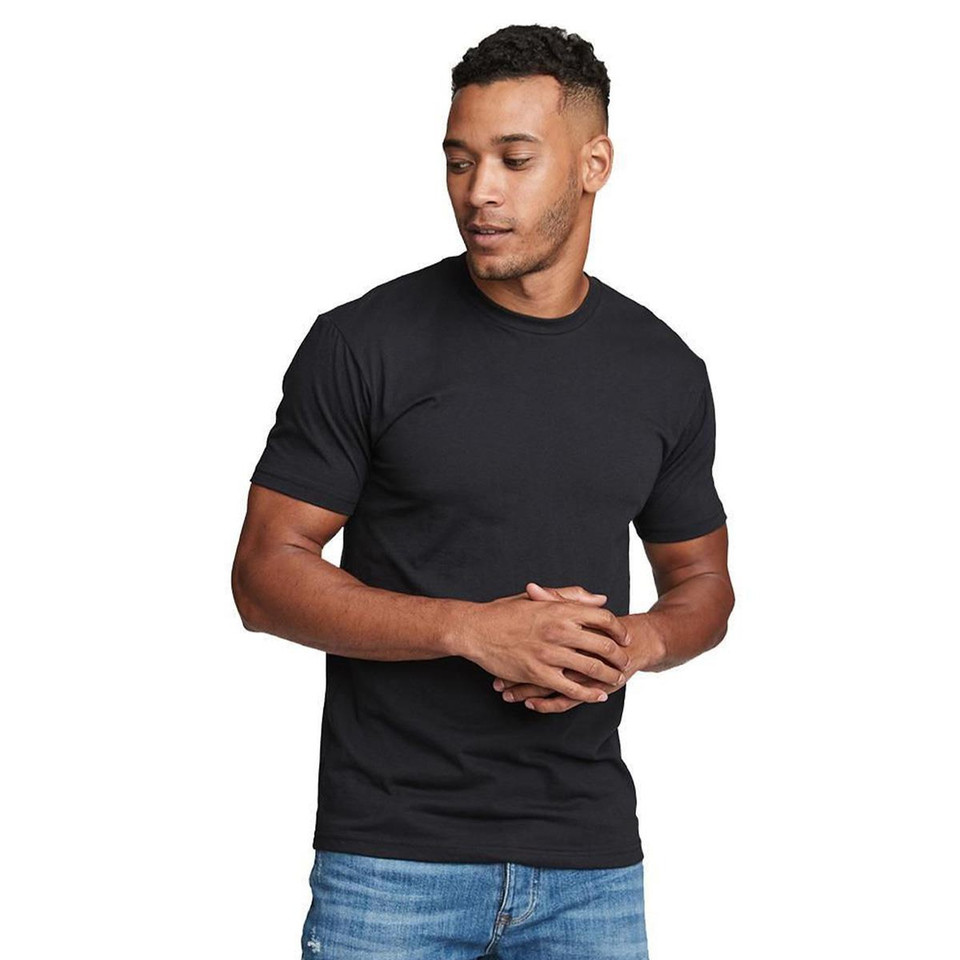 Man wearing a fitted black crew neck short sleeve t-shirt with smooth flat front, paired with blue denim jeans