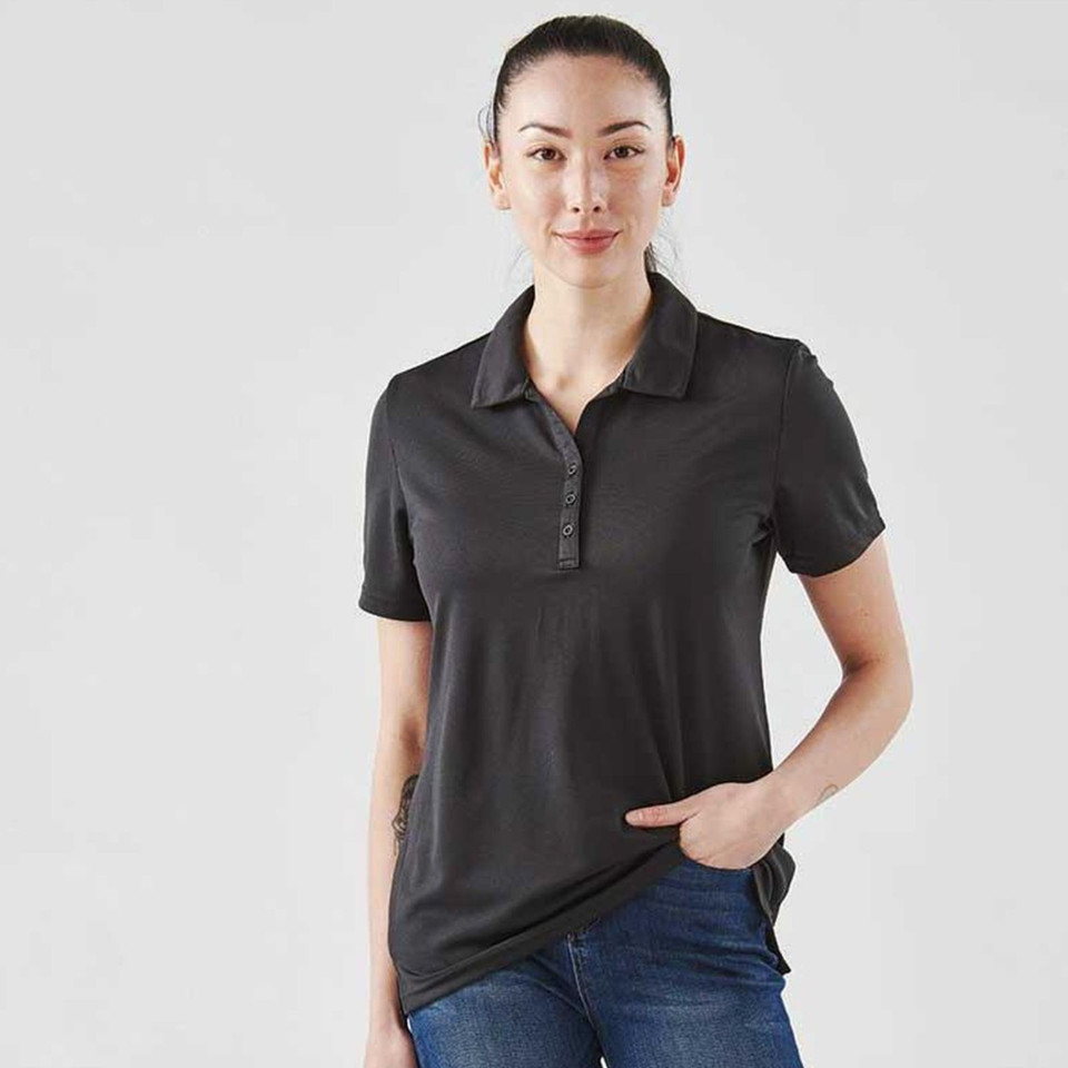 Woman wearing a charcoal short-sleeve performance polo with tonal buttons and smooth jersey fabric