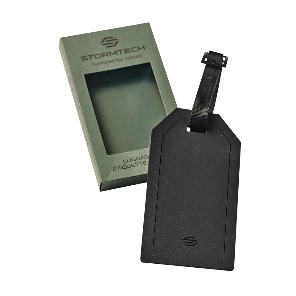Stormtech black matte luggage tag with webbing strap beside olive green branded gift box