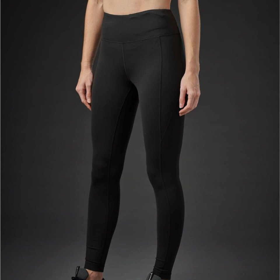 Woman wearing black high-waist performance leggings with smooth front panel and seam detailing