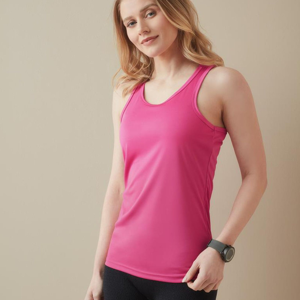 Woman wearing a hot pink racerback active singlet with scoop neck and smooth performance fabric