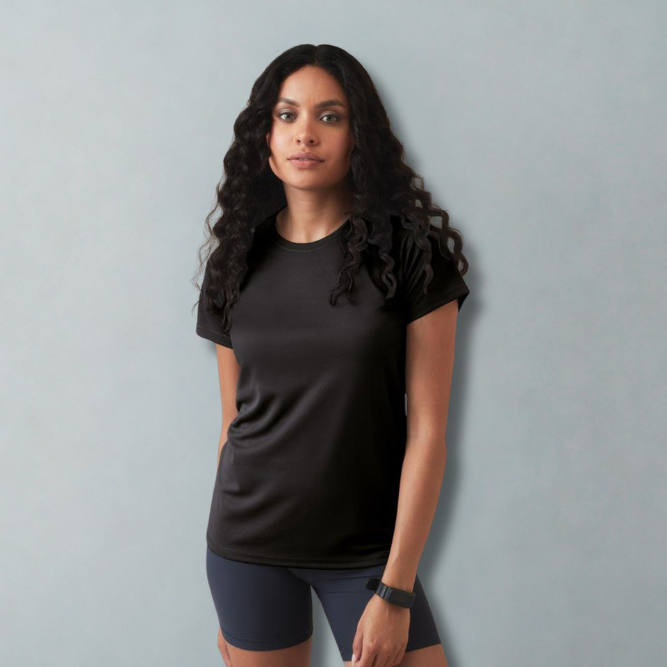 Woman wearing a black raglan performance tee with crew neck and short sleeves in active sportswear setting
