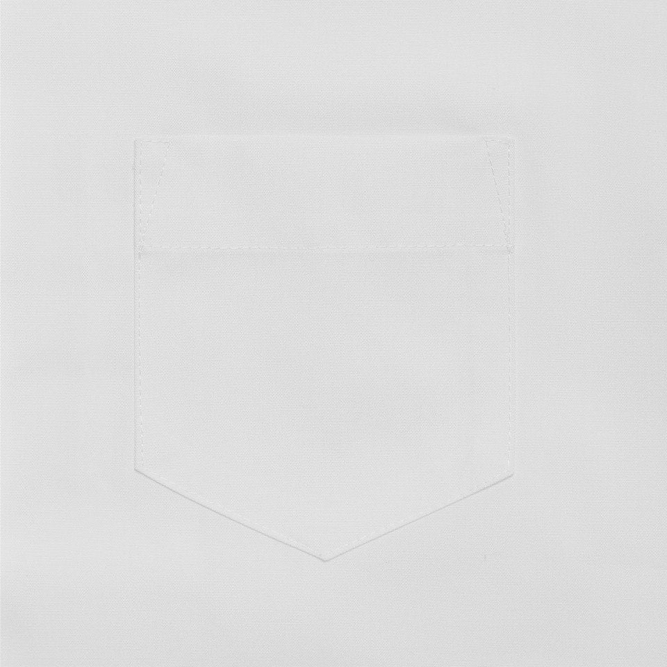 Close-up of white school blouse chest pocket with stitched edges on a flat white fabric
