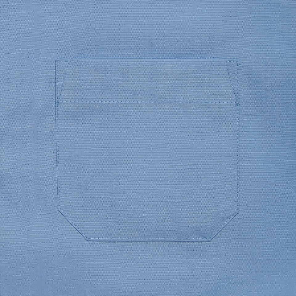 Close-up of chest pocket on a sky blue short sleeve school shirt with stitched detail