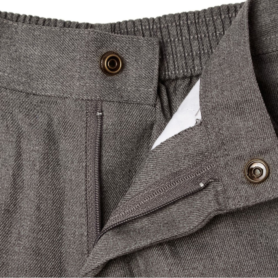 Close-up of charcoal melange pants showing zip fly, bronze snap buttons and ribbed elasticated waistband